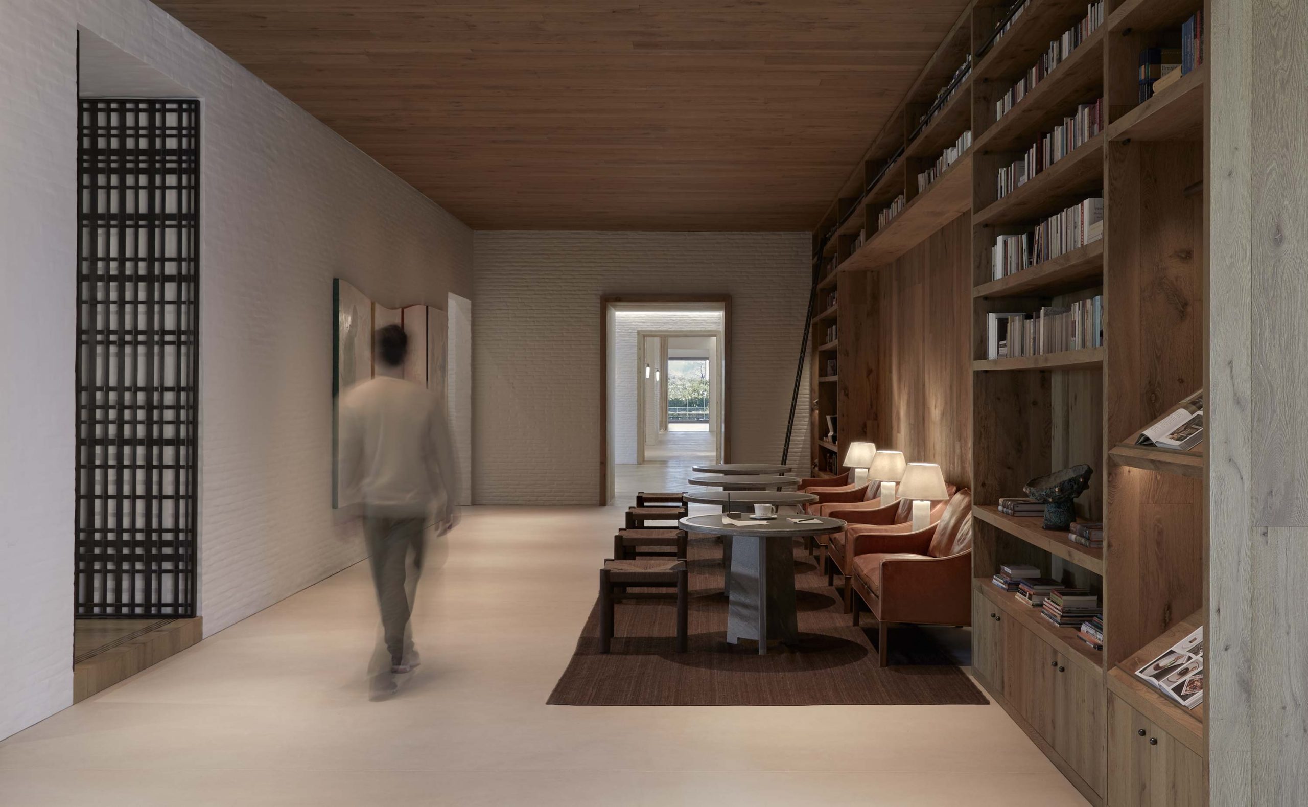 man walking corridor library | TATOÏ Club